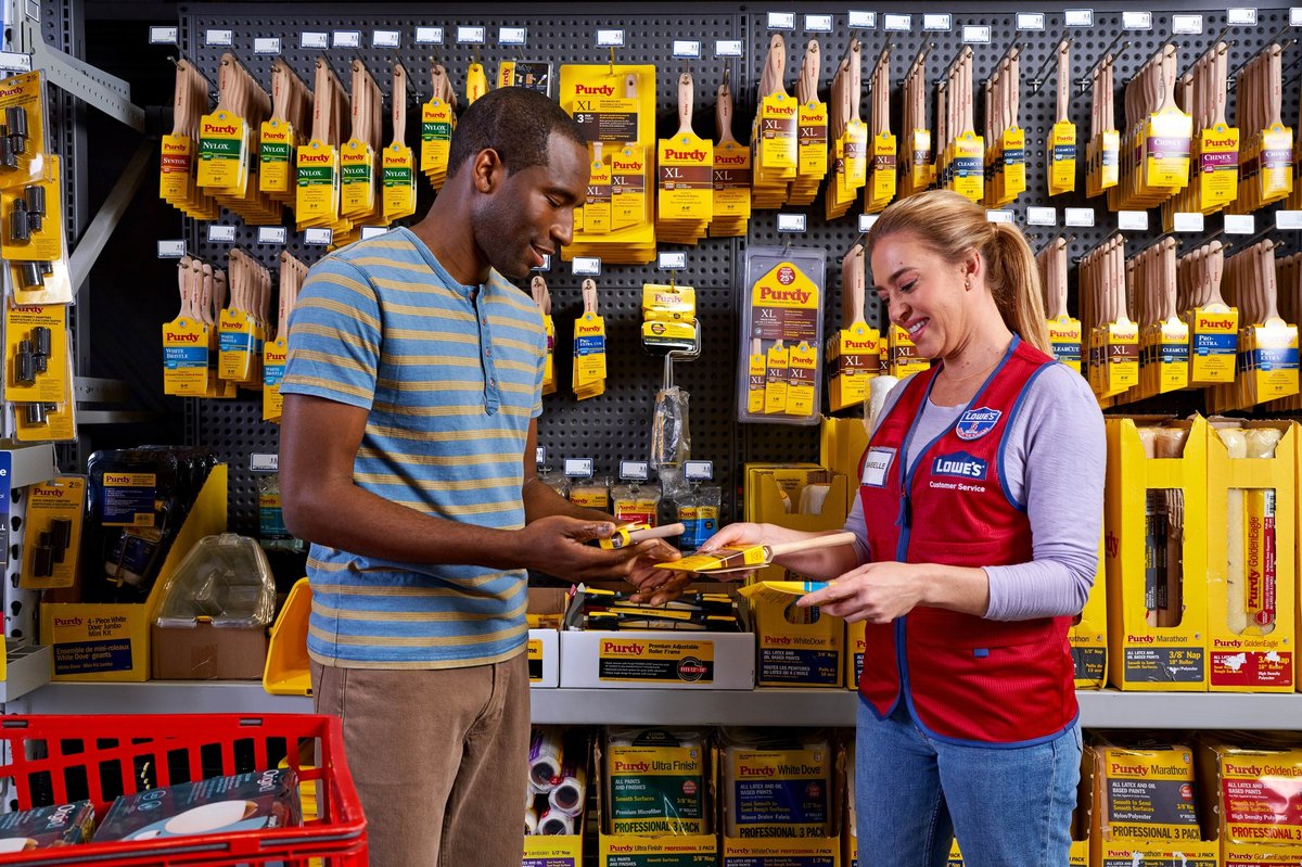 An employee assists a customer in the paint aisle inside the pet-friendly Lowe's Home Improvement in Spring Hill, FL. Photo by @LowesHomeImprovementSpringHillFlorida.