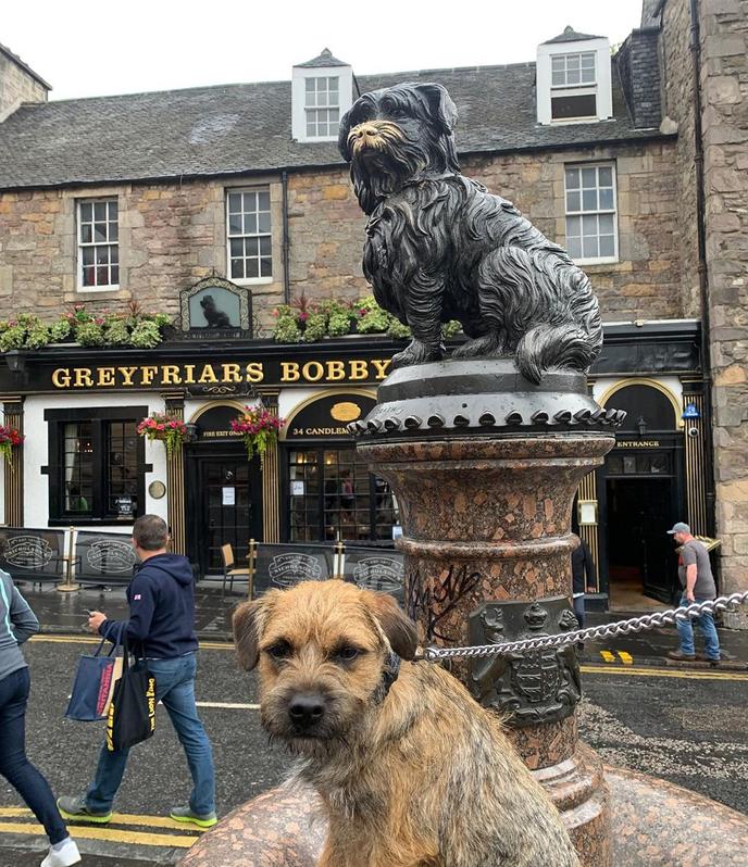 A Dog Memorial at Pet-Friendly Greyfriars Bobby in Edinburgh, UK. A Dog Statue Outside of the Pet-Friendly Greyfriars Bobby.