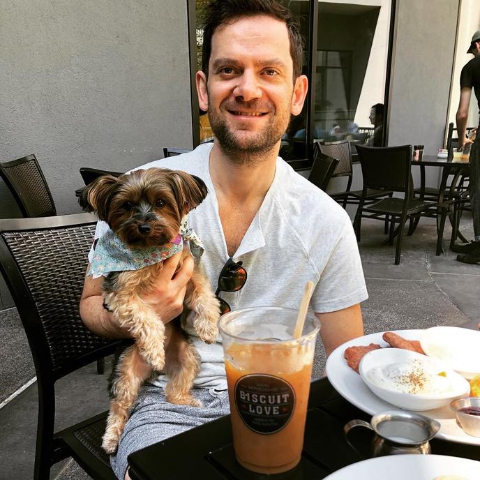 Biscuit Love is a Dog-Friendly Restaurant in Nashville. A Man and His Dog Sit on the Patio at Biscuit Love in Dog-Friendly Nasville.