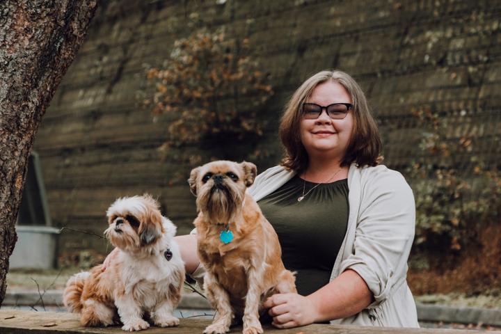 A Woman Poses With Two Dogs on Thanksgiving.