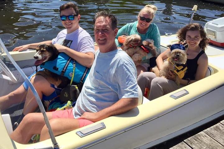 a family and their dog in a Pet-Friendly Boat Rentals