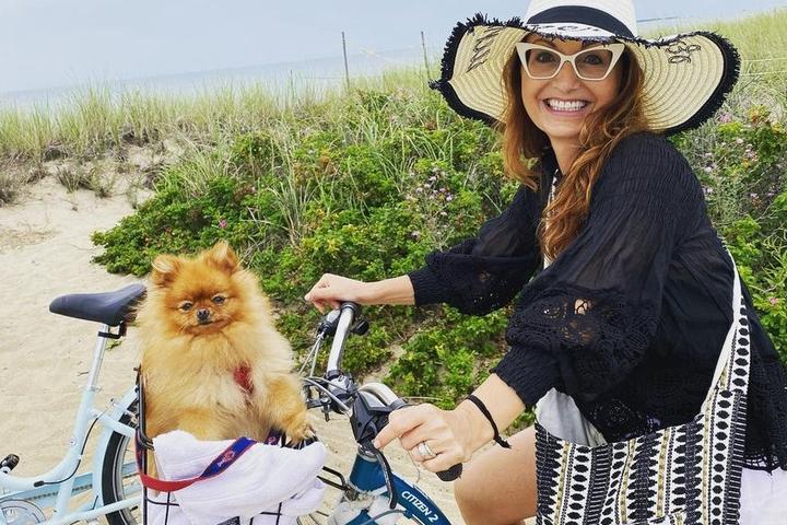 A dog and her owner on a bike ride in Martha's Vineyard.