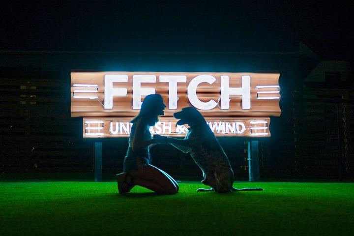 A woman and her dog at Fetch Park dog park