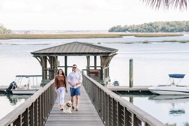 Couple walking with dog in Montage Palmetto Bluff