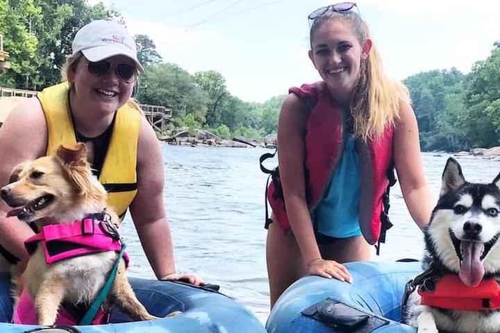 Two women and two dogs enjoy tubing at dog-friendly Palmetto Outdoors