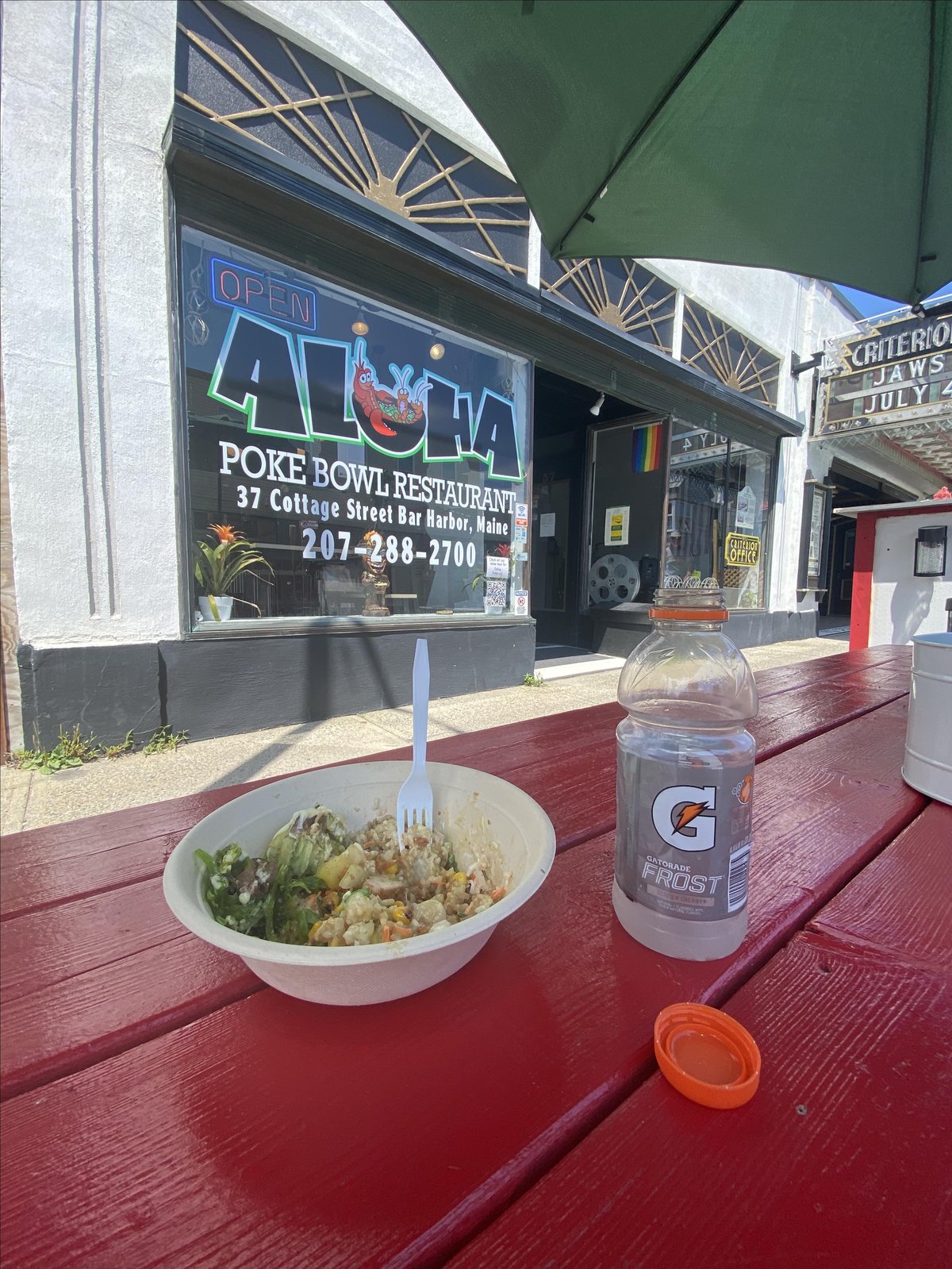 Dine at a picnic table with an umbrella at dog-friendly Aloha in Bar Harbor, Maine.