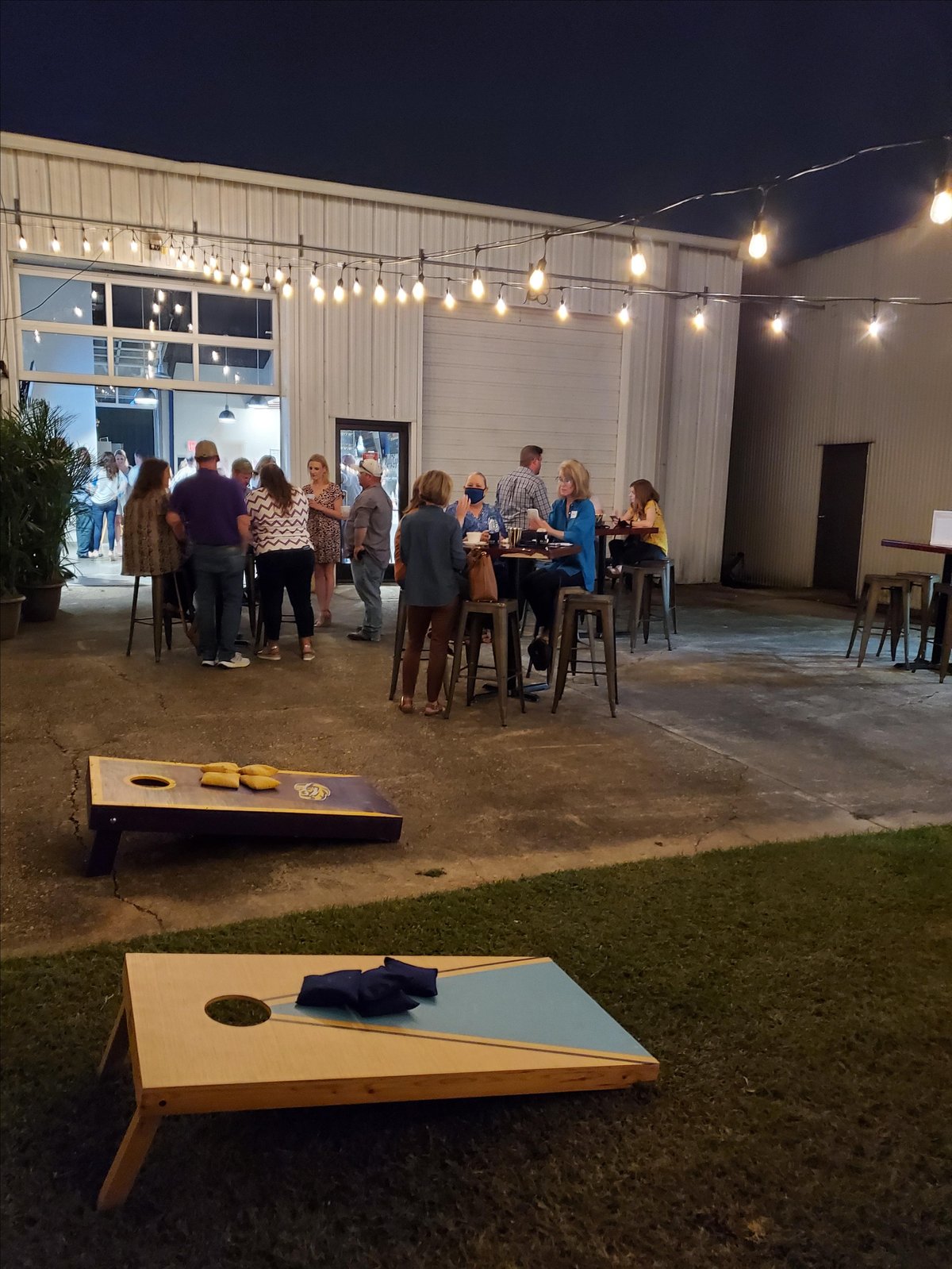 Photo of patrons visiting pet-friendly Baton Rouge, LA, brewery Rally Cap Brewing Company.