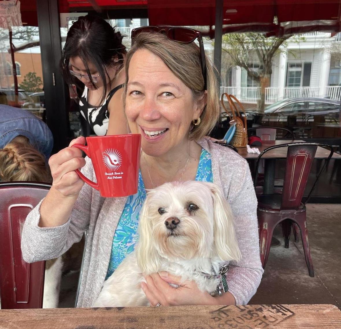 A pup and his parent enjoying a cup of coffee from the pet-friendly Ruby Slipper in Pensacola, FL.