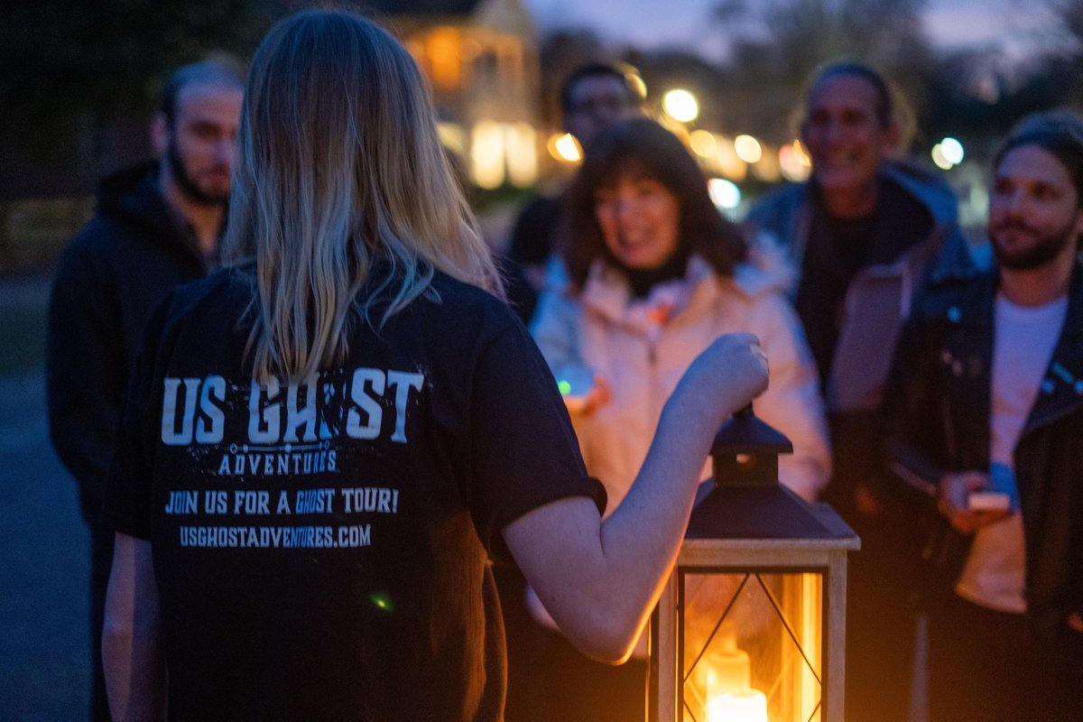 A tour guide telling stories to people during the pet-friendly US Ghost Adventures in Fall River, MA.