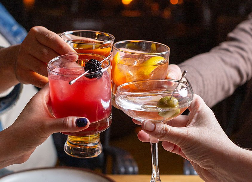 Friends cheers their drinks during a visit to a dog-friendly restaurant in Hunter, NY, Prospect. Photo by Scribner's Catskill Lodge.