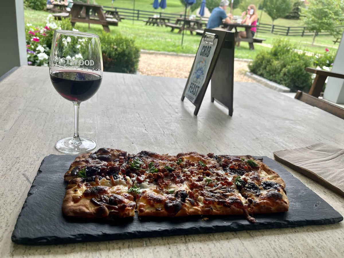 A glass of wine and a flatbread pizza from Charlottesville, VA's dog-friendly Eastwood Farm and Winery.